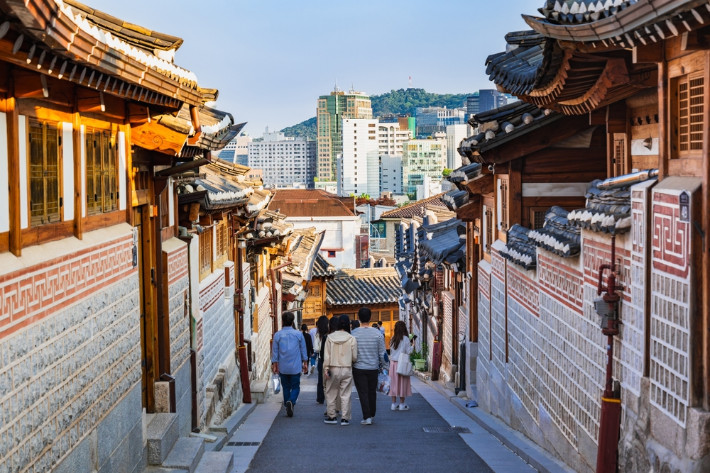 people walking through a traditional street things to do in seoul