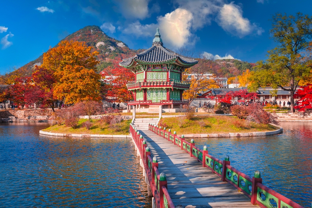colorful palace surrounded by lake, mountain, and autumn colors things to do in seoul