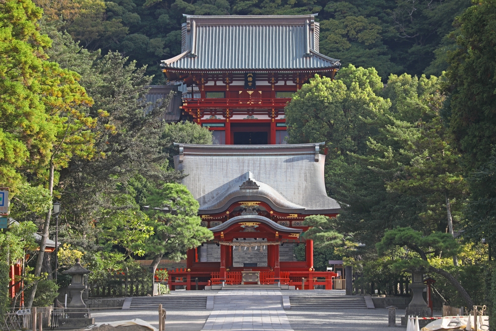 This is the main shrine (jogu) of Tsurugaoka Hachimangu Shrine in Kamakura. It is surrounded by tress and red
