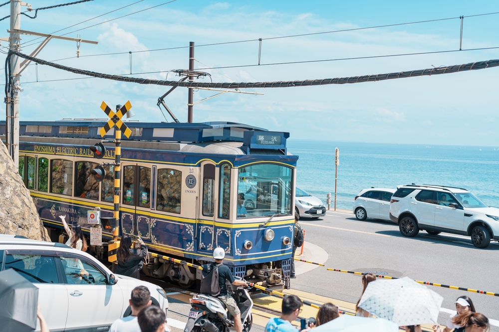 Kamakura Kokomae Station Railway and The Enoshima Dentetsu Line with sea background. Landmark and popular for tourists attraction near Tokyo. 
