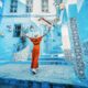 girl in orange dress standing in a blue house area traveling to morocco