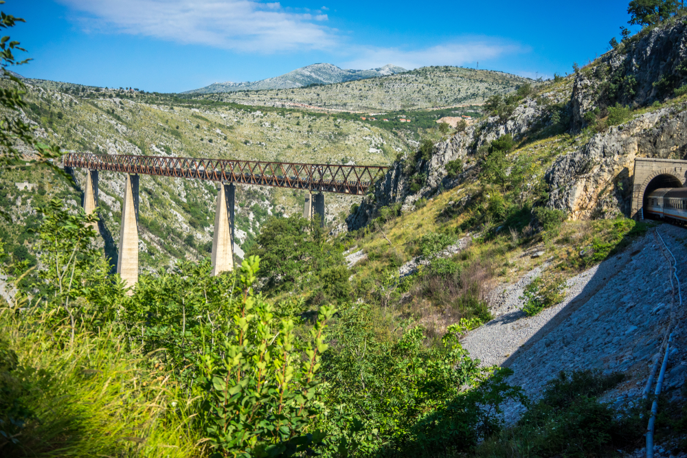 railway viaduct while train passes through a tunnel
