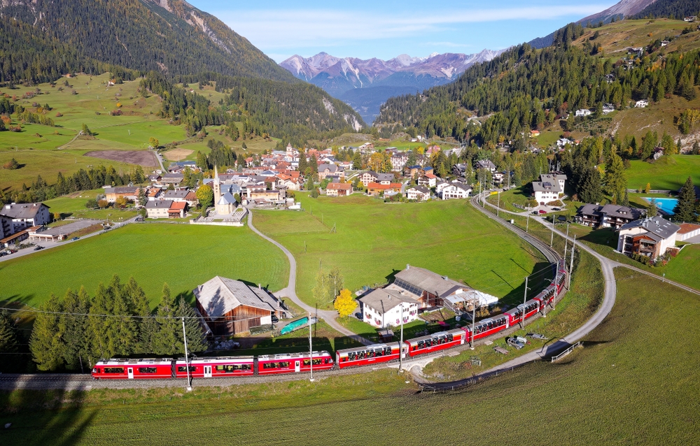 aerial view of a train in a valley european train trips