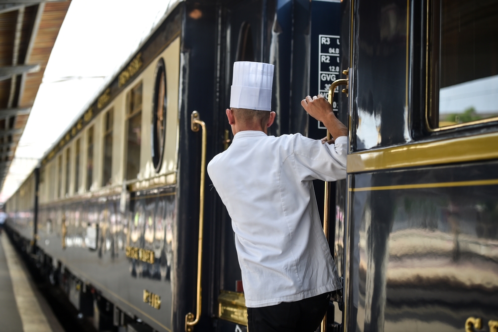 chef looking out from a vintage train