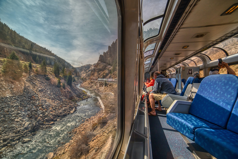 Amtrak Train crossing through the Colorado Rocky Mountains with peak Fall Colors in September