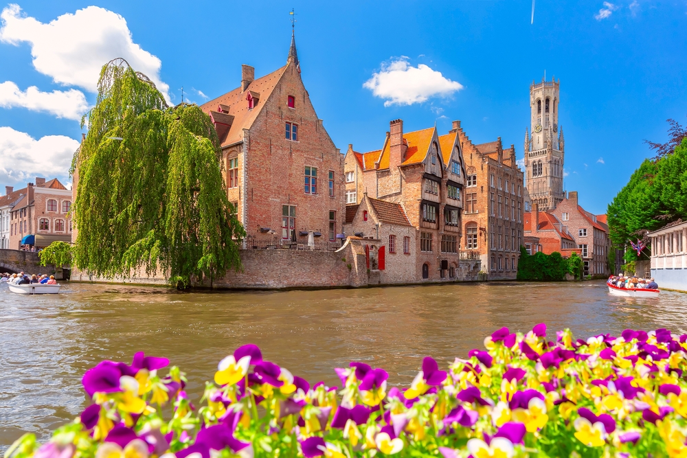 Scenic sunny medieval fairytale town and tower Belfort from the quay Rosary in Bruges, Belgium