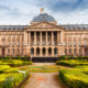 old building with belgium flag and garden in front of it brussels itinerary