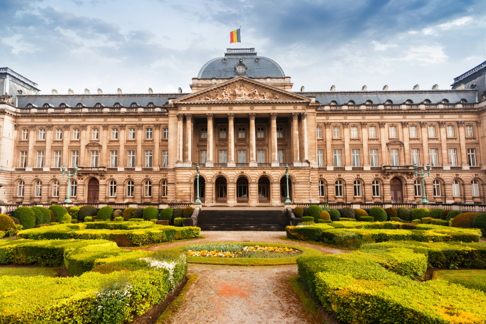 old building with belgium flag and garden in front of it brussels itinerary