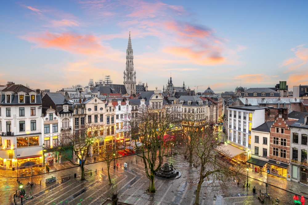 Belgium plaza and skyline with the Town Hall tower at dusk. . 