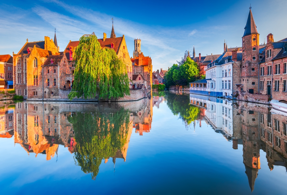 Morning golden hour on Rozenhoedkaai pier, beautiful reflection on Brugge water canal