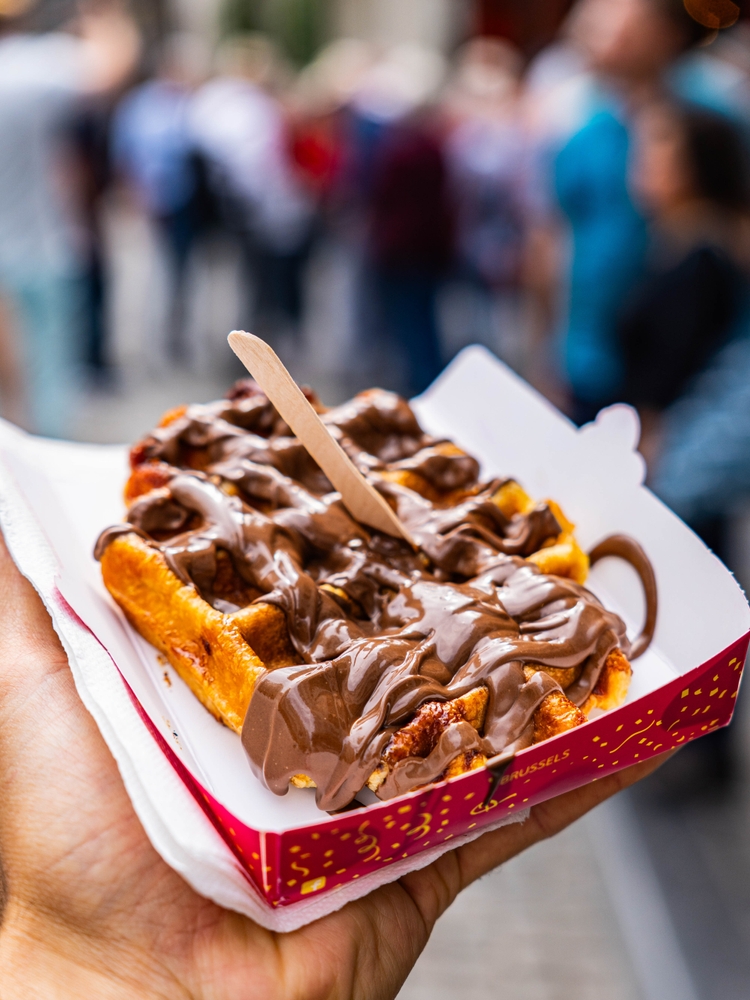 Belgian waffle with chocolate syrup covering it