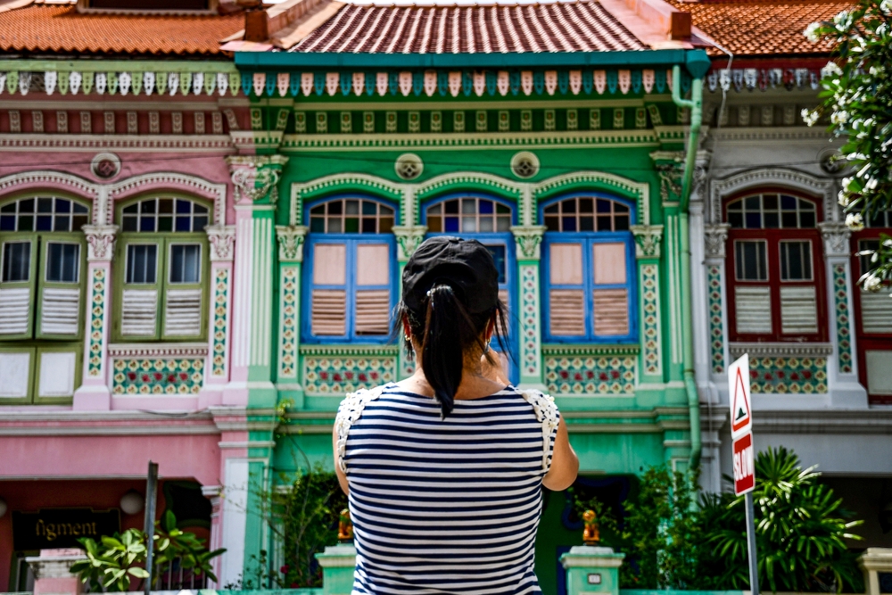 woman taking photos of the colorful buildings