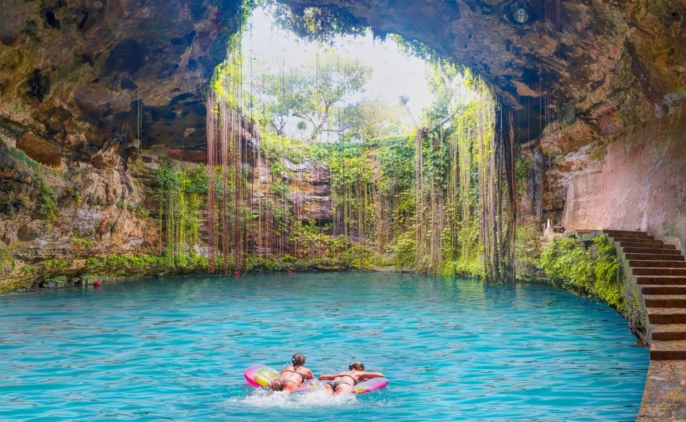 two girls enjoying in a cenote cancun travel tips