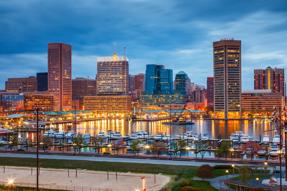 view of the town in the evening with buildings lit up baltimore inner harbour