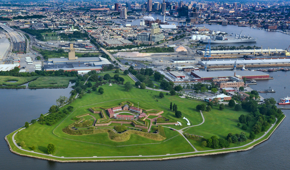 aeria view of a green land with buildings connected to the main town traveling to Baltimore