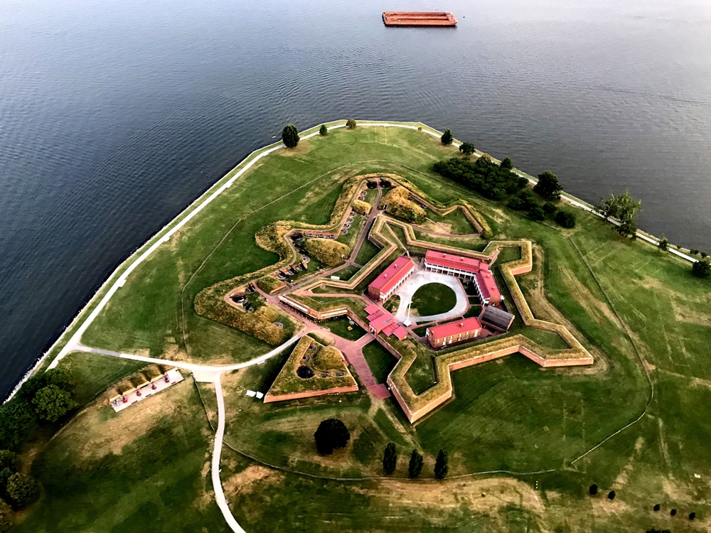 aerial view of a building with gardens on a hill beside a lake things to do in baltimore beyond the inner harbor