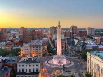 aerial view of a road cross-section with a long monument and buildings around it things to do in baltimore beyond the inner harbor