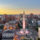 aerial view of a road cross-section with a long monument and buildings around it things to do in baltimore beyond the inner harbor