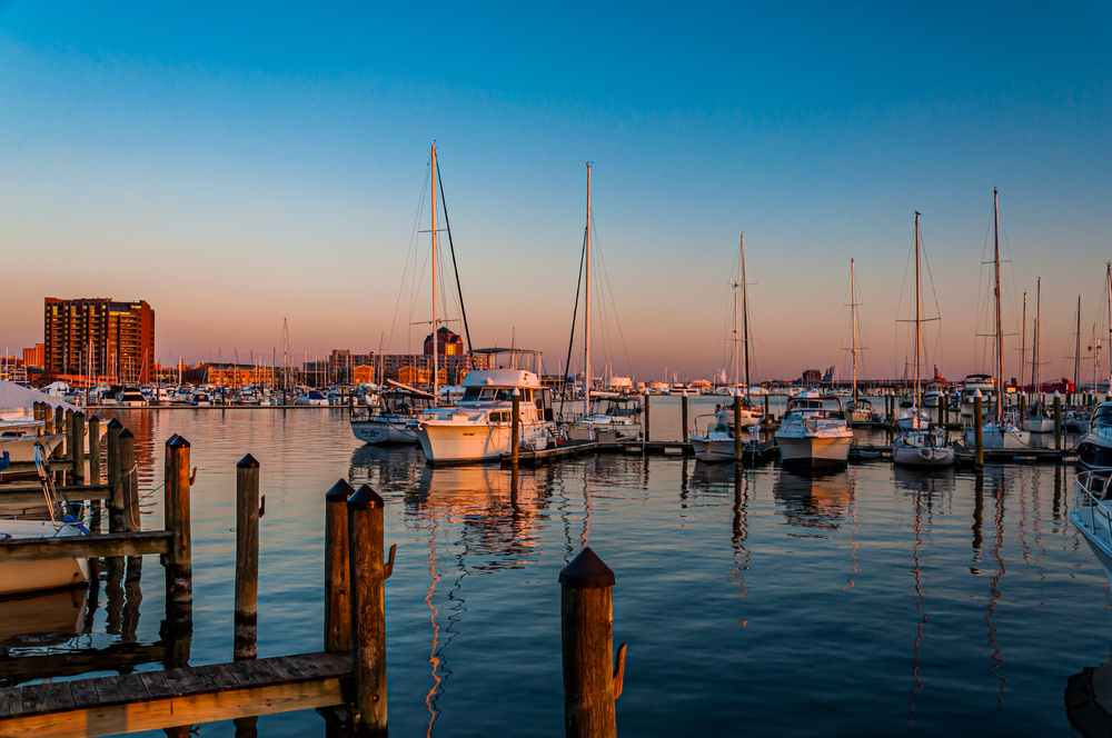 sunset from a harbour with boats in front best neighborhoods in baltimore